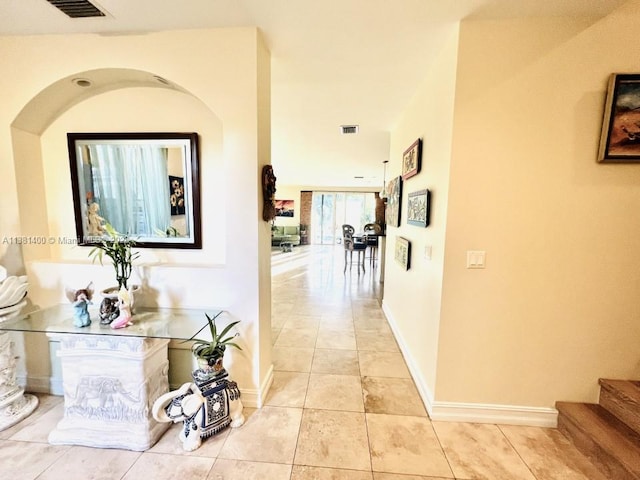 hall featuring light tile floors