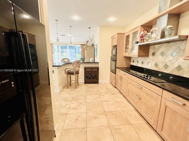 kitchen with a kitchen breakfast bar, light tile floors, tasteful backsplash, black appliances, and hanging light fixtures