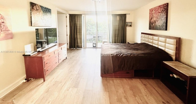 bedroom featuring access to exterior and light wood-type flooring