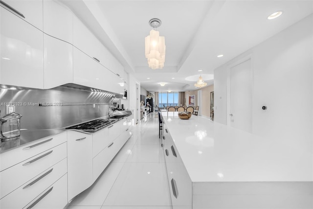 kitchen featuring white cabinets, light tile flooring, sink, and stainless steel gas stovetop