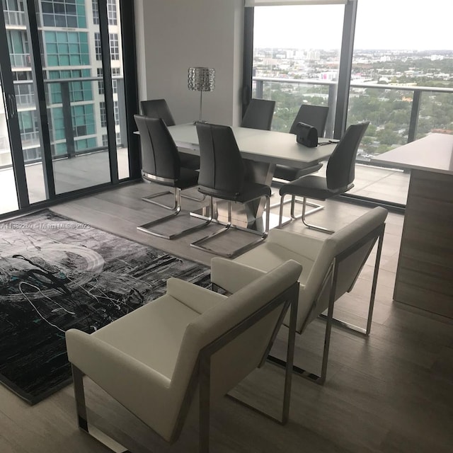 dining space featuring light hardwood / wood-style floors and expansive windows