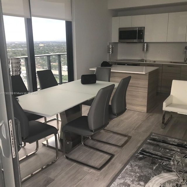 dining room with hardwood / wood-style flooring and sink