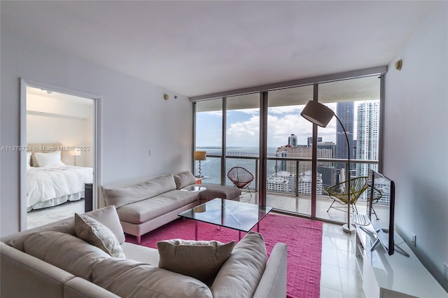 tiled living room with expansive windows and a water view