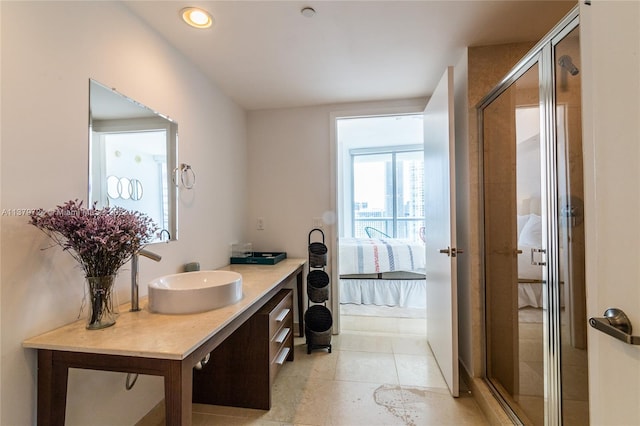 bathroom featuring vanity, tile floors, and walk in shower