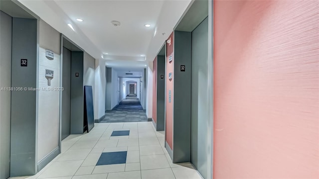 corridor with light tile flooring and elevator