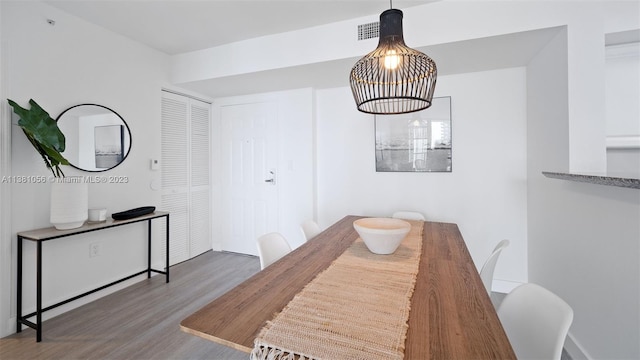 dining space with dark hardwood / wood-style flooring