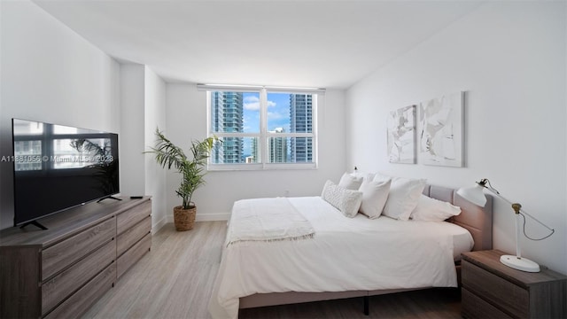 bedroom with hardwood / wood-style flooring