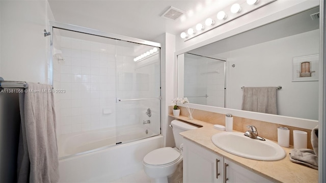 full bathroom featuring combined bath / shower with glass door, tile flooring, large vanity, and toilet