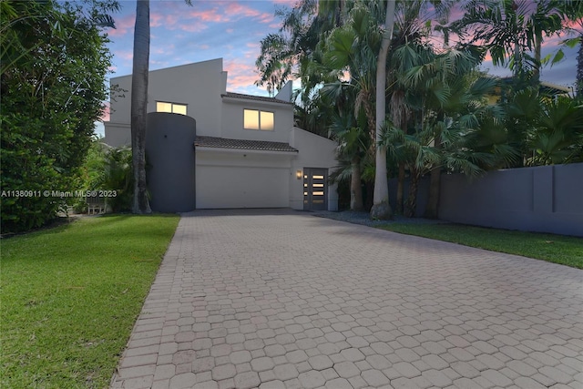 view of front of property featuring a yard and a garage