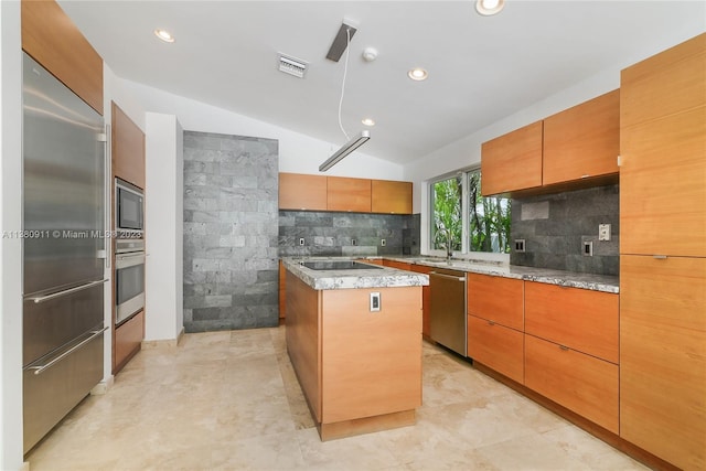 kitchen with a kitchen island, tasteful backsplash, built in appliances, vaulted ceiling, and light tile patterned floors