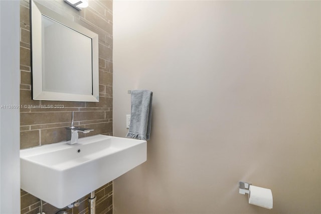 bathroom with tasteful backsplash and sink