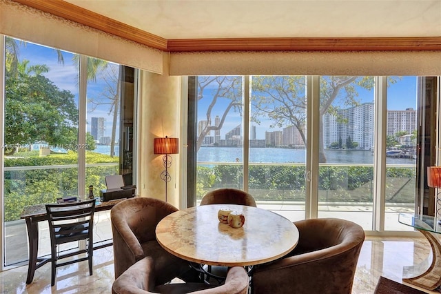 dining area featuring a water view and light tile floors