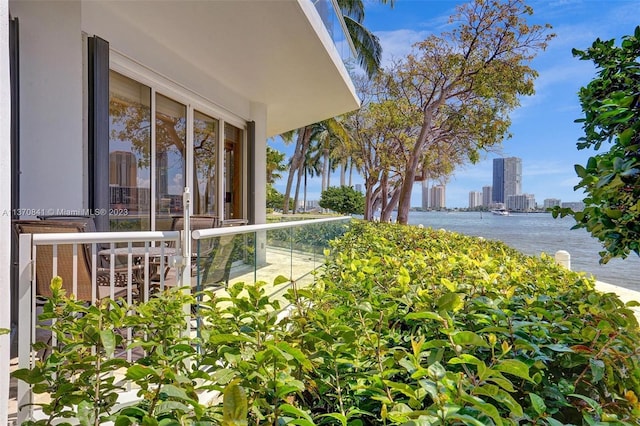 exterior space featuring a balcony and a water view