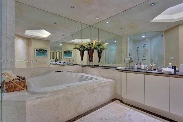 bathroom with tiled bath, vanity, and tile flooring