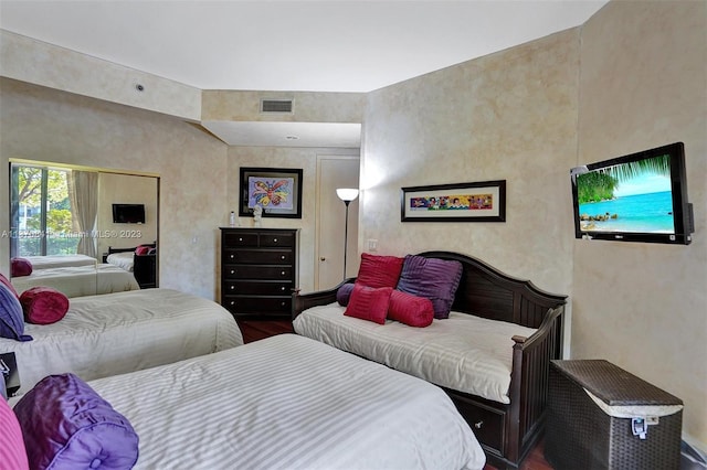 bedroom with dark wood-type flooring