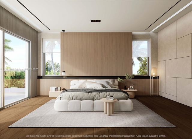 bedroom featuring multiple windows, access to exterior, and hardwood / wood-style flooring