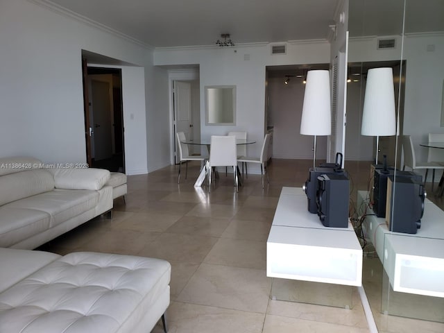 living room featuring ornamental molding and light tile flooring