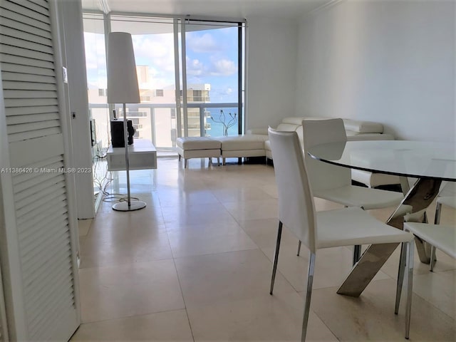 tiled dining room with a wall of windows