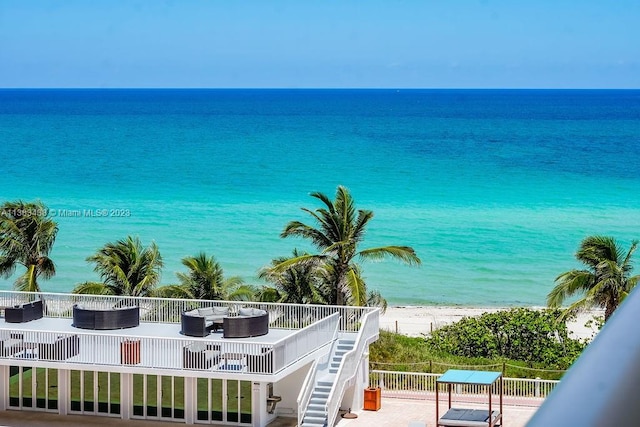 water view with stairway and a view of the beach