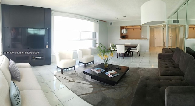 living room featuring light tile patterned flooring and visible vents