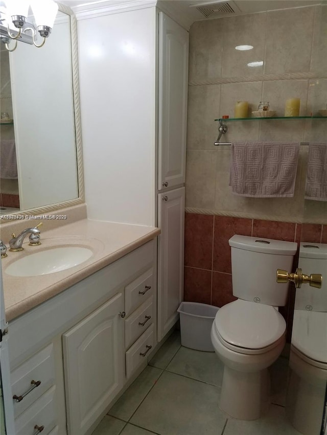 bathroom featuring visible vents, tile walls, vanity, and tile patterned floors