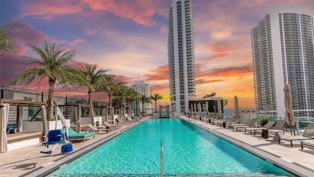 view of pool at dusk