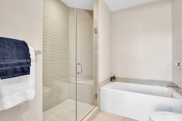 bathroom with toilet, independent shower and bath, and tile flooring