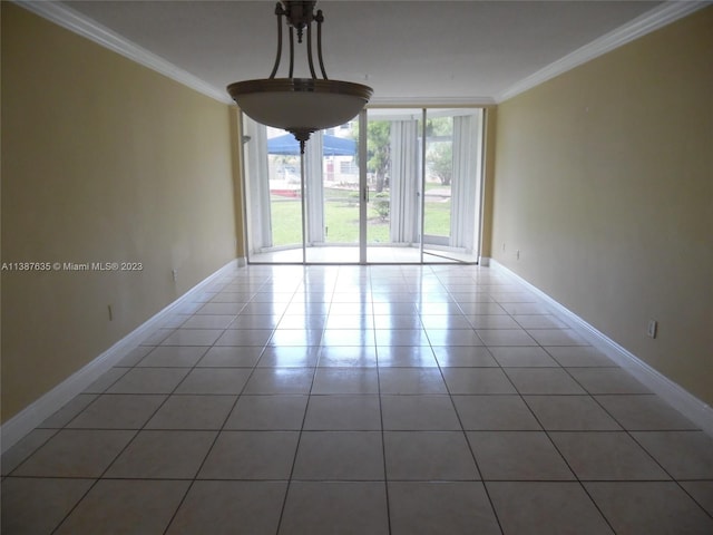 empty room featuring tile flooring and crown molding