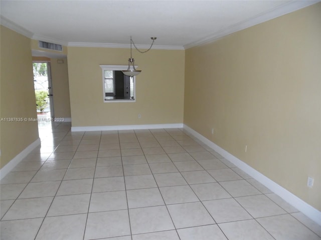 unfurnished room featuring ornamental molding and light tile floors