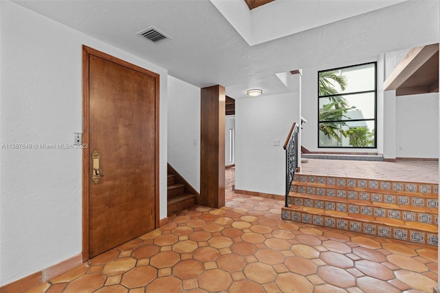 stairs featuring light tile flooring