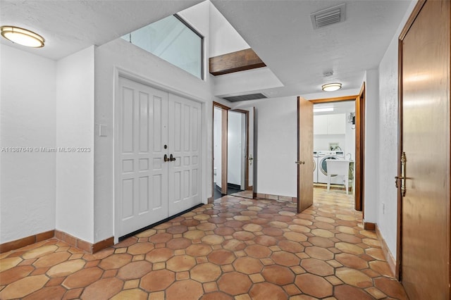 tiled entrance foyer with washer / dryer