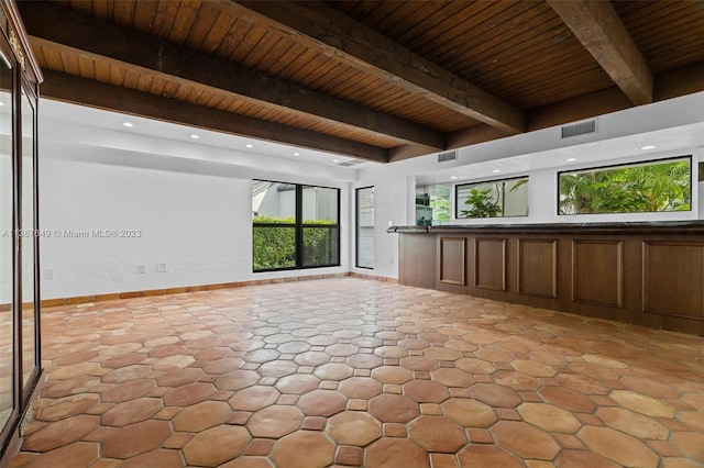 unfurnished room with light tile floors, wood ceiling, and beamed ceiling