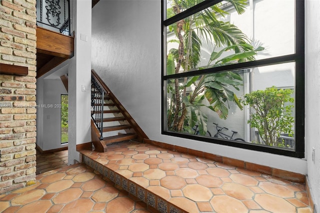 interior space with brick wall and tile flooring