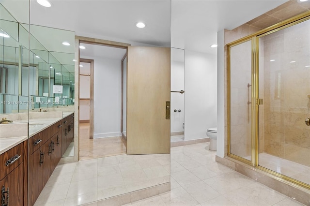 bathroom featuring vanity, tile flooring, a shower with shower door, and toilet