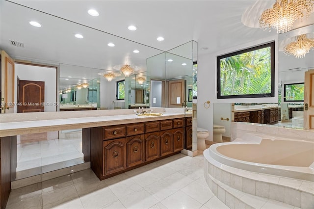 bathroom with toilet, a bidet, tile floors, a notable chandelier, and vanity