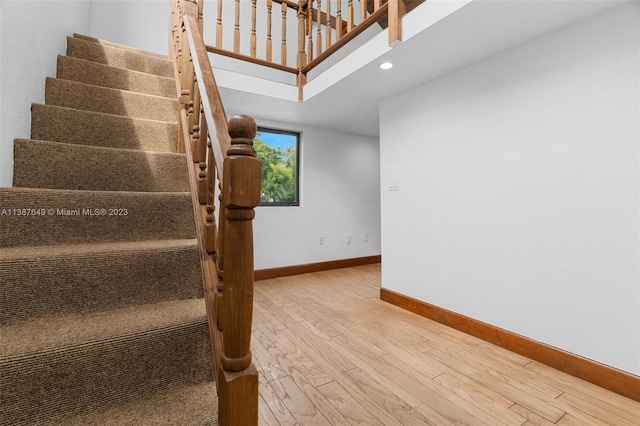 stairway featuring light wood-type flooring