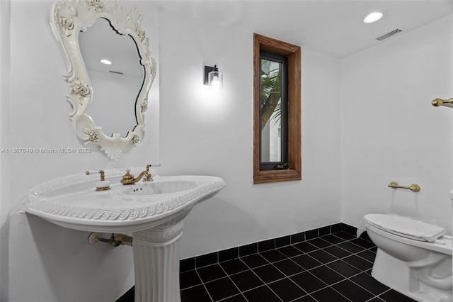 bathroom with tile floors and toilet