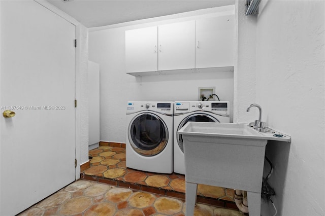 washroom featuring cabinets, tile floors, separate washer and dryer, and sink