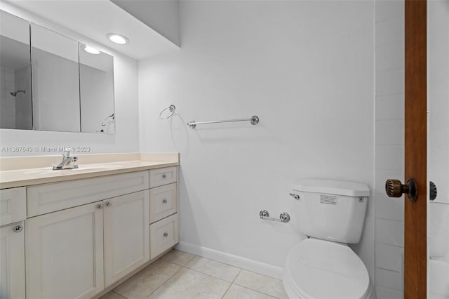 bathroom featuring toilet, tile floors, and vanity