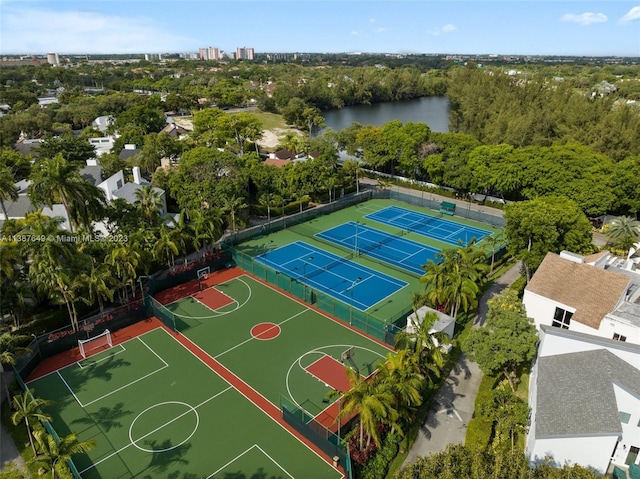 view of sport court featuring tennis court and a water view