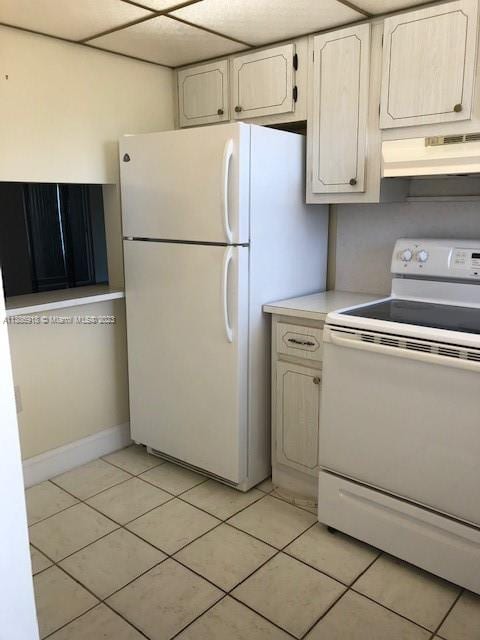 kitchen featuring light tile floors, white appliances, white cabinets, and custom exhaust hood