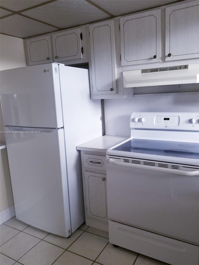 kitchen featuring white appliances and light tile floors