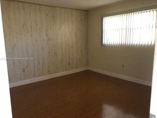 spare room featuring dark hardwood / wood-style floors