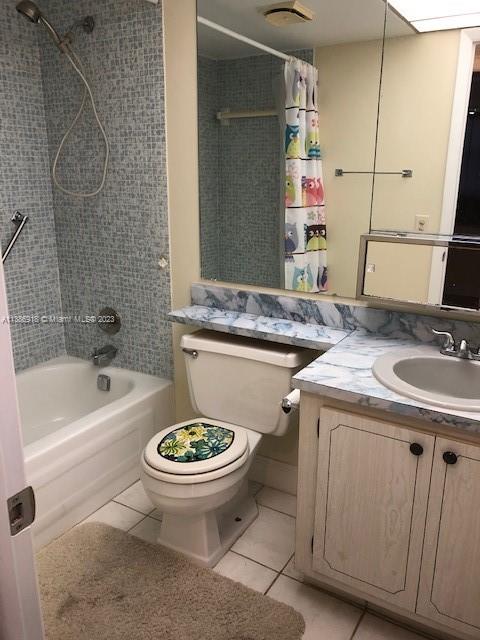 full bathroom featuring shower / tub combo, toilet, tile flooring, and vanity