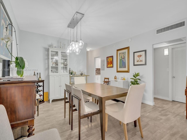 dining space with light hardwood / wood-style floors