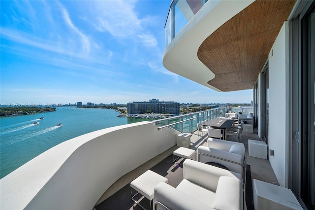 balcony with a water view and outdoor lounge area