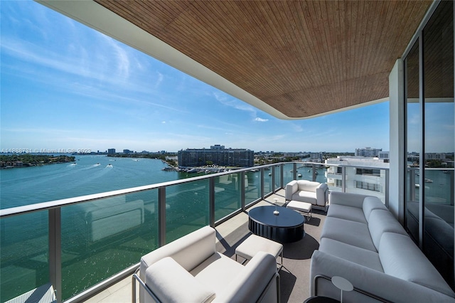 balcony with outdoor lounge area and a water view