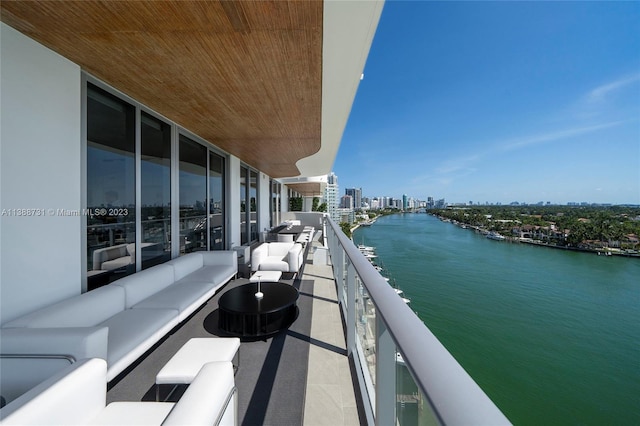 balcony with an outdoor hangout area and a water view