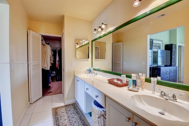 bathroom featuring tile floors, dual sinks, and vanity with extensive cabinet space