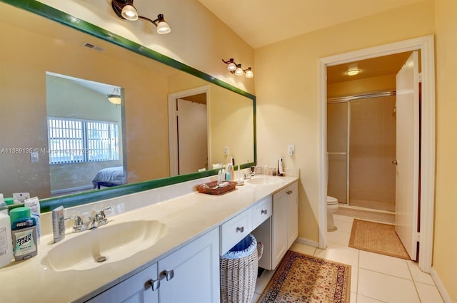 bathroom with toilet, double sink, a shower with shower door, tile flooring, and oversized vanity